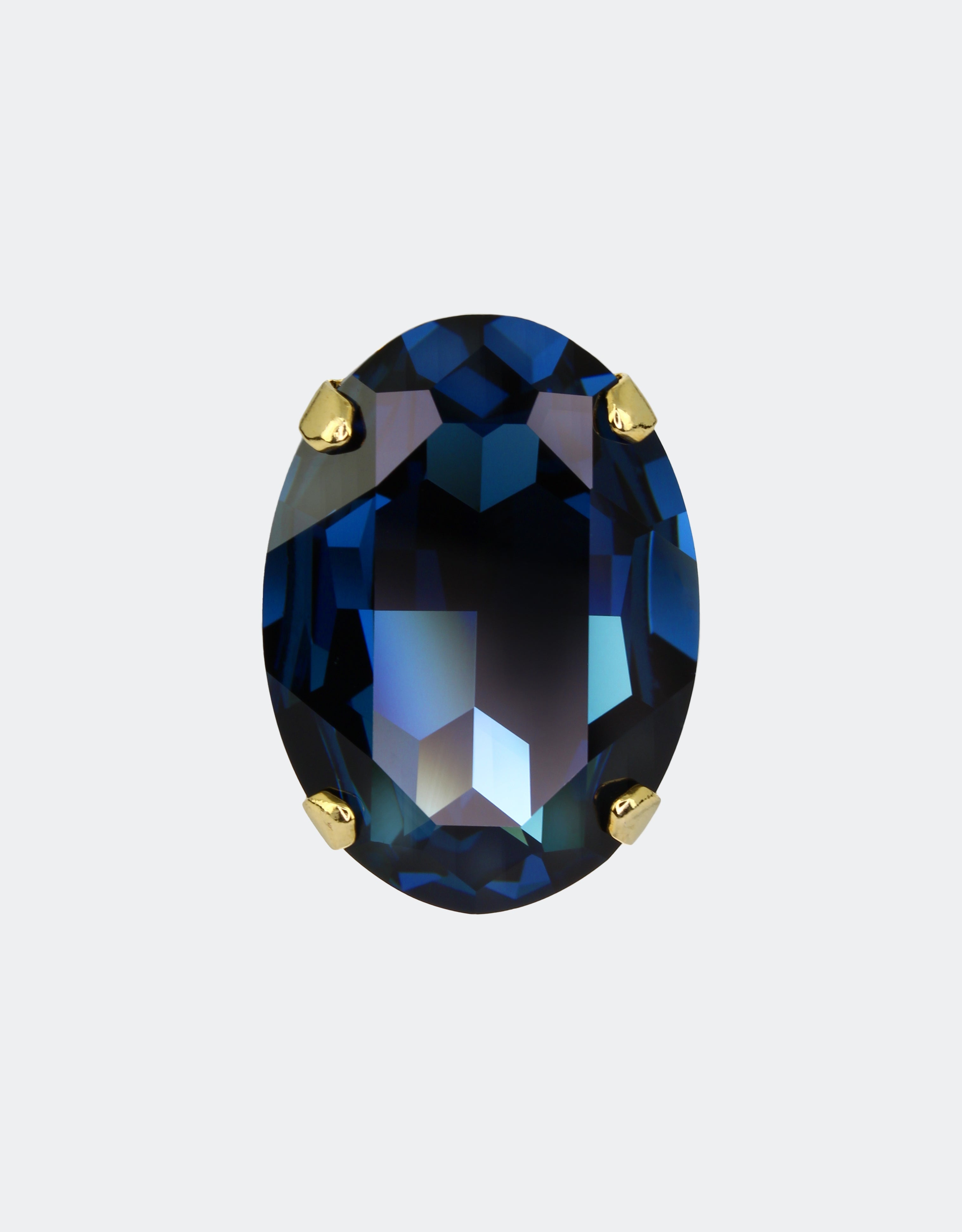 A large blue oval crystal ring with gold-colored settings