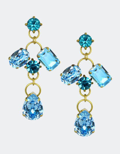 A pair of vintage earrings with pear-shaped crystals in blue and other geometric shapes, mounted on gold-colored metal.