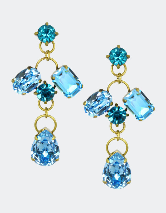 A pair of vintage earrings with pear-shaped crystals in blue and other geometric shapes, mounted on gold-colored metal.