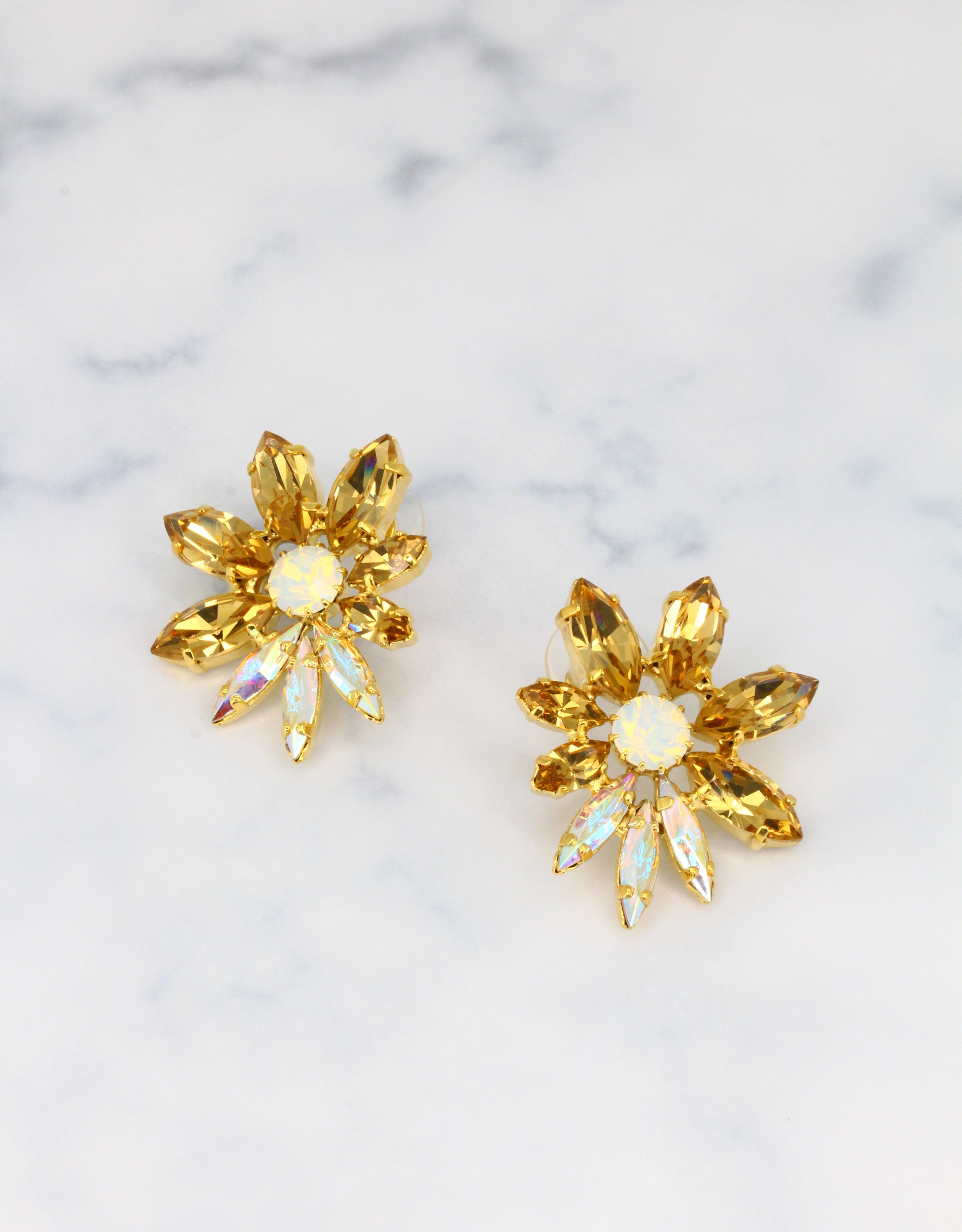 Selene Crystal Emery amber marquis crystal earrings in gold – 5cm handcrafted stud jewellery with a luminous firework silhouette, designed for statement occasion styling. Free worldwide shipping on orders over £199.