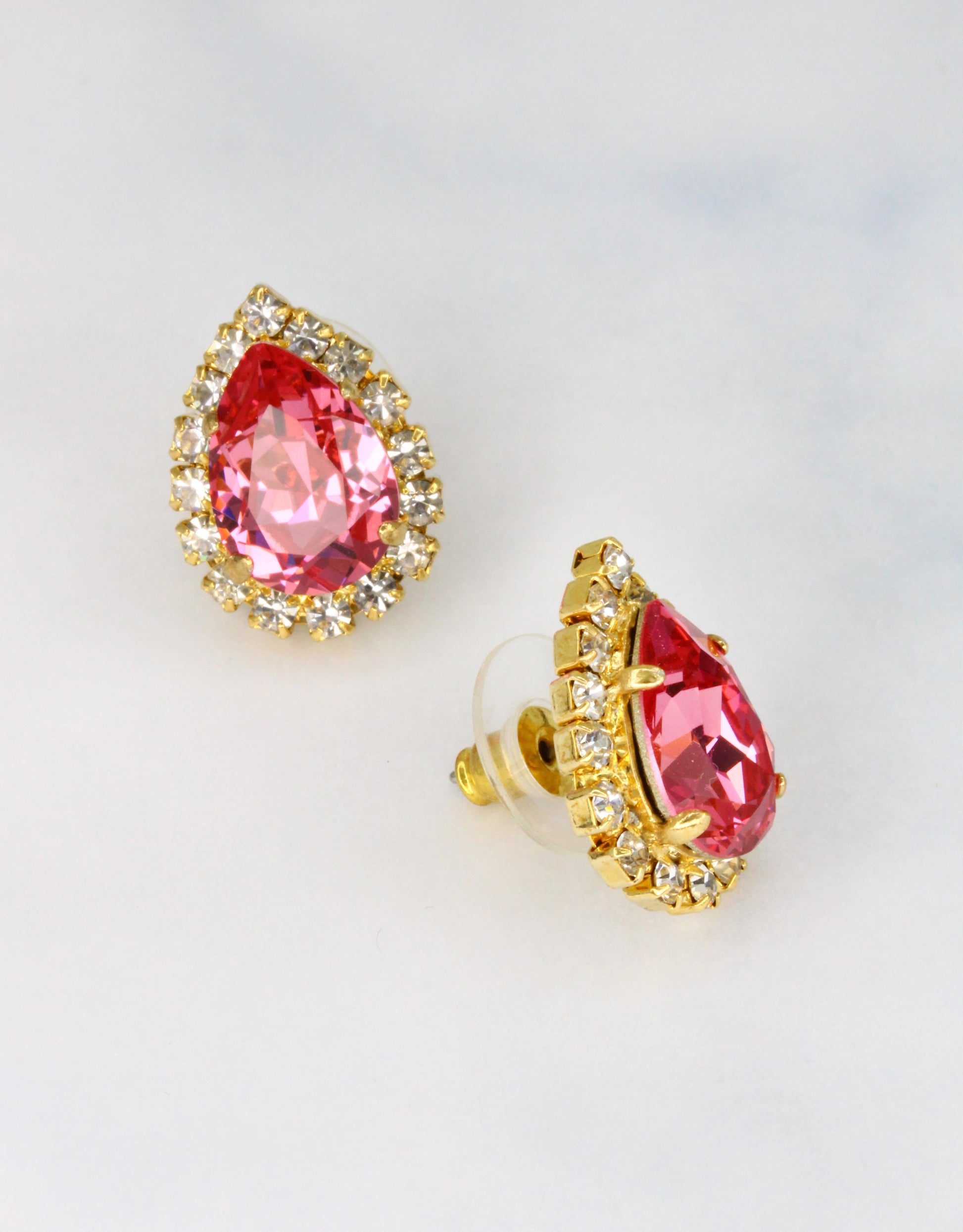 Selene Crystal Lily Pear Rosetta studs in coral pink crystal with gold halo – warm-toned pear-shaped stud earrings with fine crystal surround for parties and occasion wear.