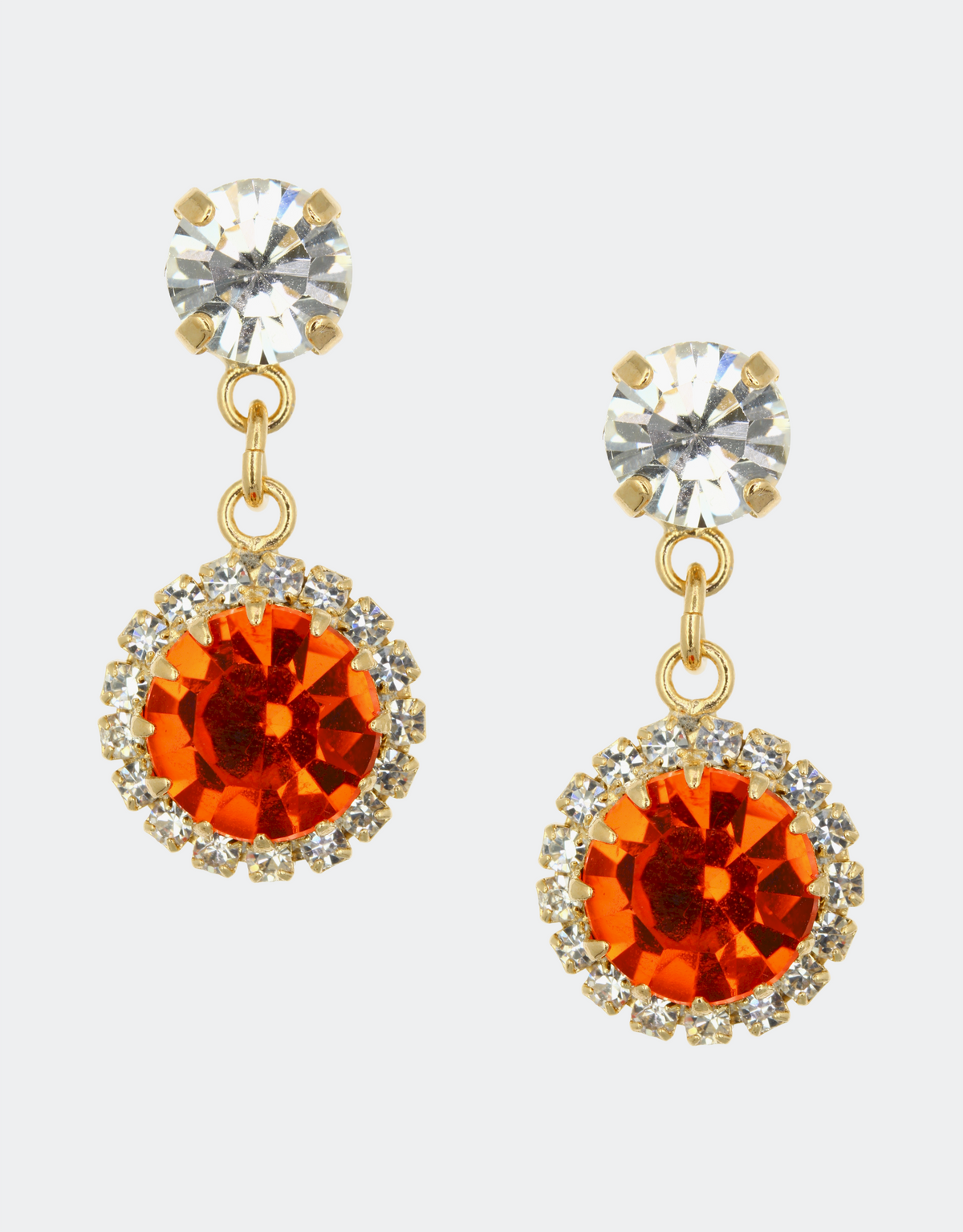 A pair of drop earrings with orange crystals surrounded by smaller clear crystals, attached to gold-colored metal by selene crystal