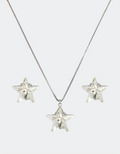 A jewelry set consisting of a necklace and a pair of earrings with a star design, featuring genuine crystals and an adjustable chain.
