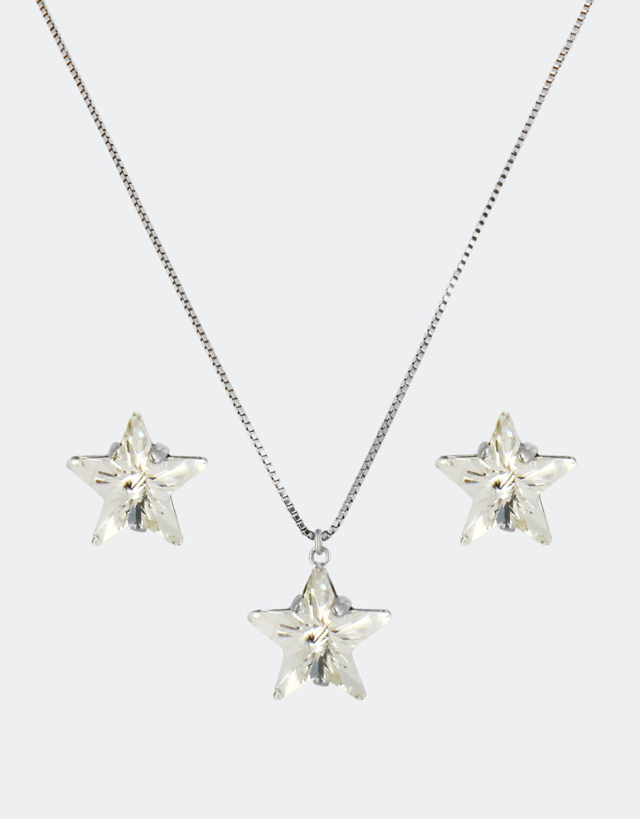 A jewelry set consisting of a necklace and a pair of earrings with a star design, featuring genuine crystals and an adjustable chain.